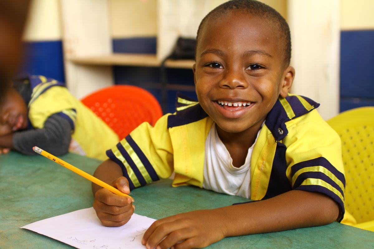 Boy writing in Cameroon with pencil